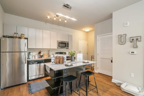 Kitchen with silver appliances and breakfast bar